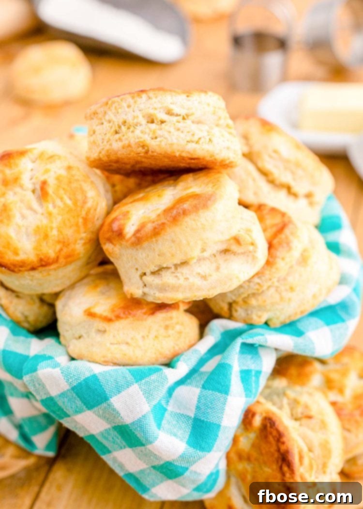 Close up photo of buttermilk biscuits in a teal and white checkered napkin.