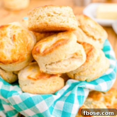 Close up photo of buttermilk biscuits in a teal and white checkered napkin.