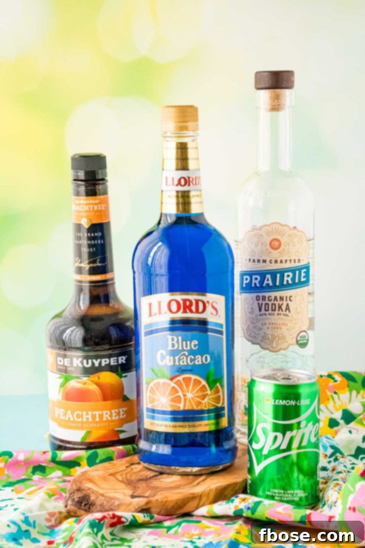 Ingredients laid out on a table to make a Sex in the Driveway drink: vodka, peach schnapps, blue curaçao, lemon-lime soda, and a lemon for garnish.