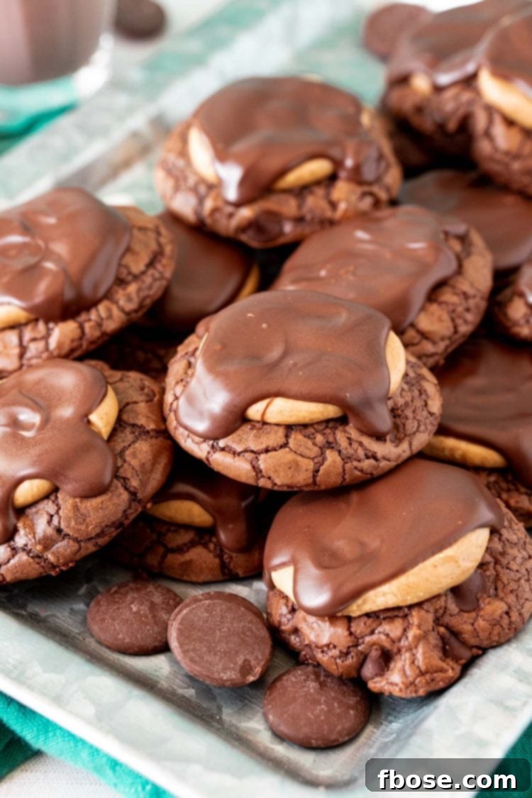 Buckeye cookies arranged neatly on a tin serving tray, showcasing their perfect round shape and glistening chocolate tops.
