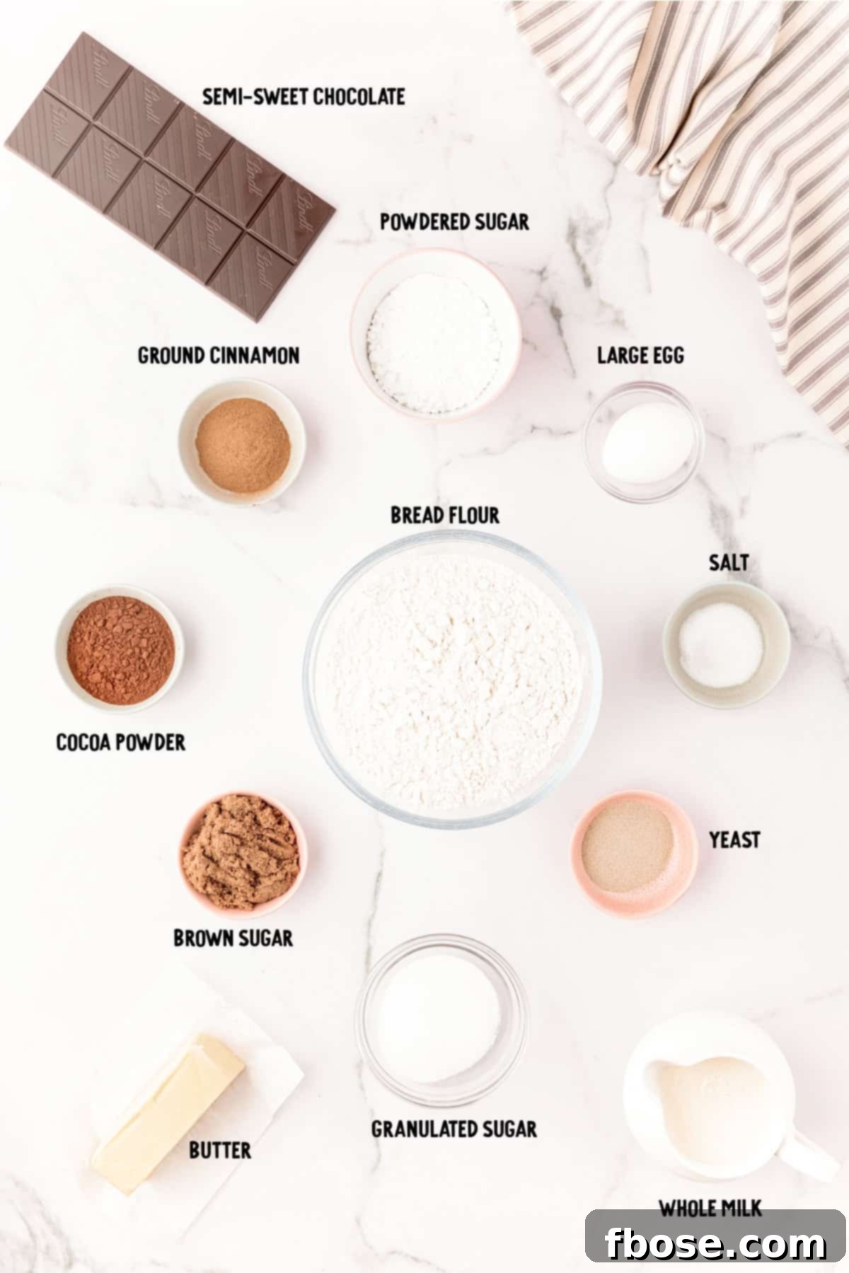 Decadent Chocolate Cinnamon Swirls 4 Ingredients to make chocolate cinnamon rolls on a marble counter.