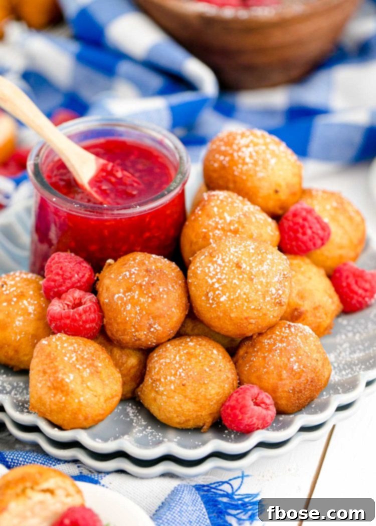 Fried cheesecake bites on a scalloped gray plate.