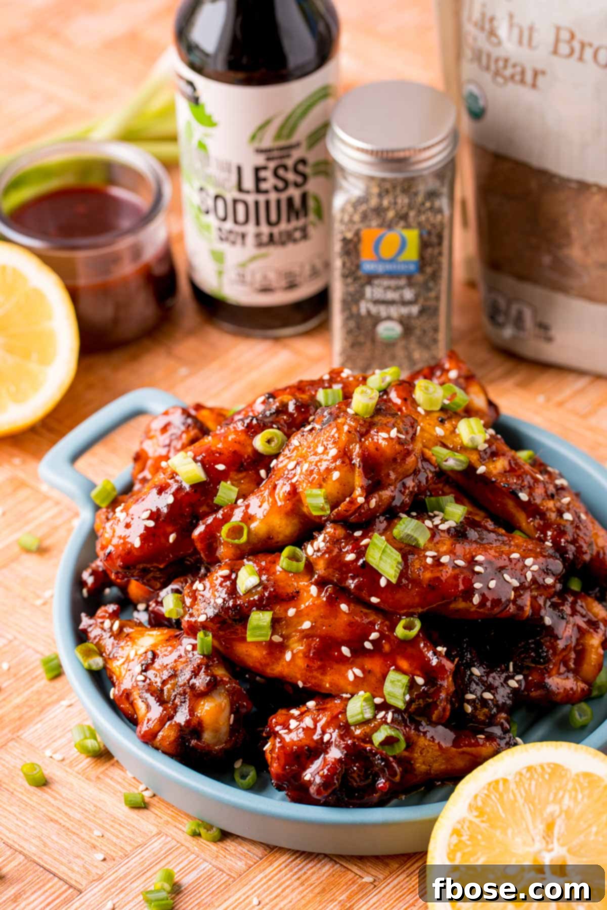 Sticky Korean BBQ Chicken Wings 2 Close up photo of grilled Korean BBQ chicken wings on a blue serving plate.