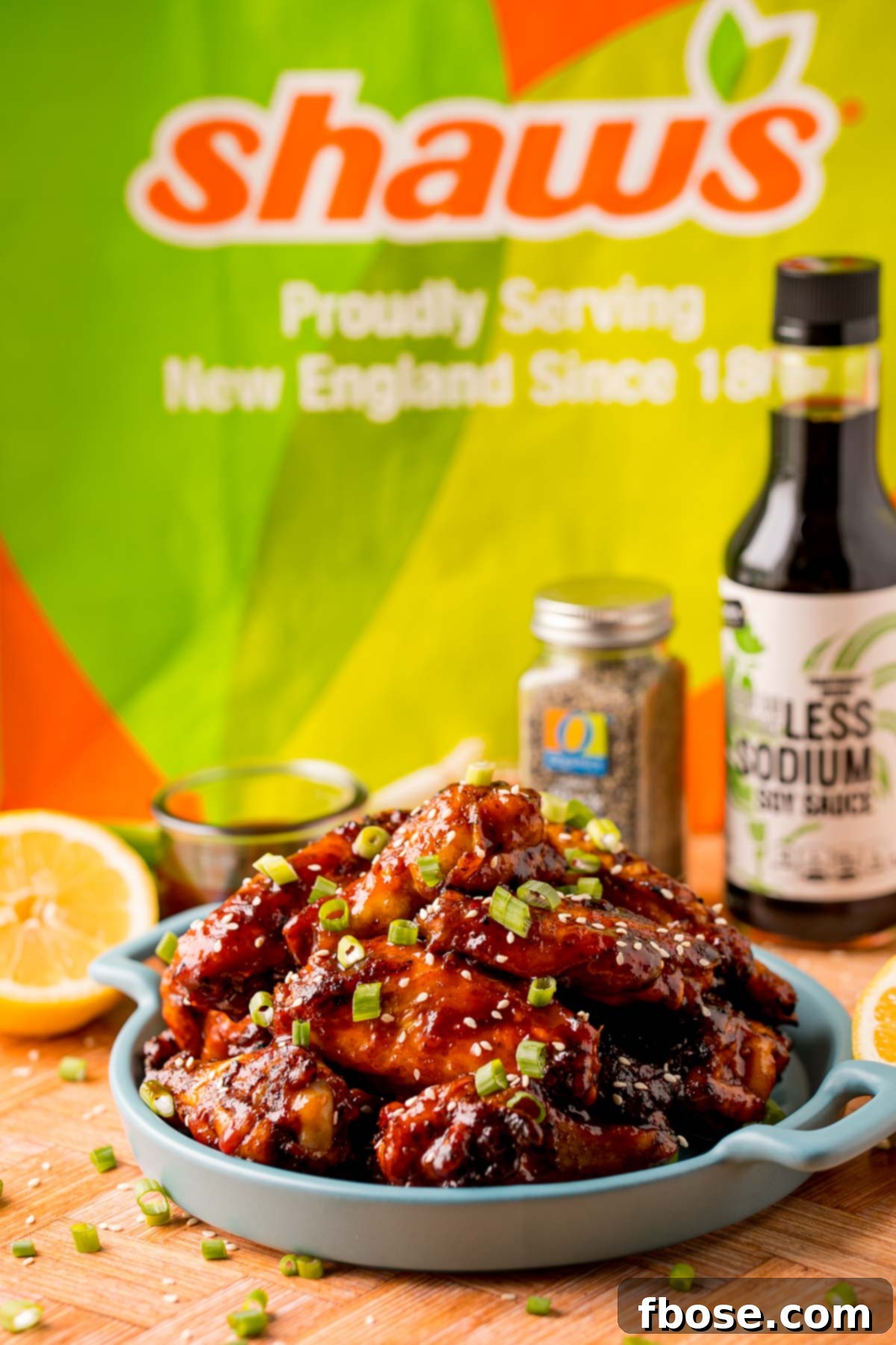 Sticky Korean BBQ Chicken Wings 8 Korean BBQ Chicken Wings on a blue plate with a Shaw's bag in the background.