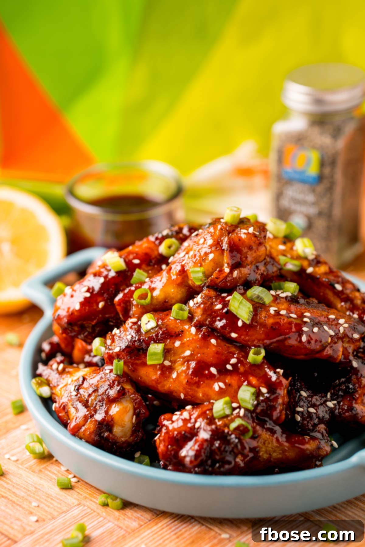 Sticky Korean BBQ Chicken Wings 10 Close up photo of grilled Korean BBQ chicken wings on a blue serving plate.