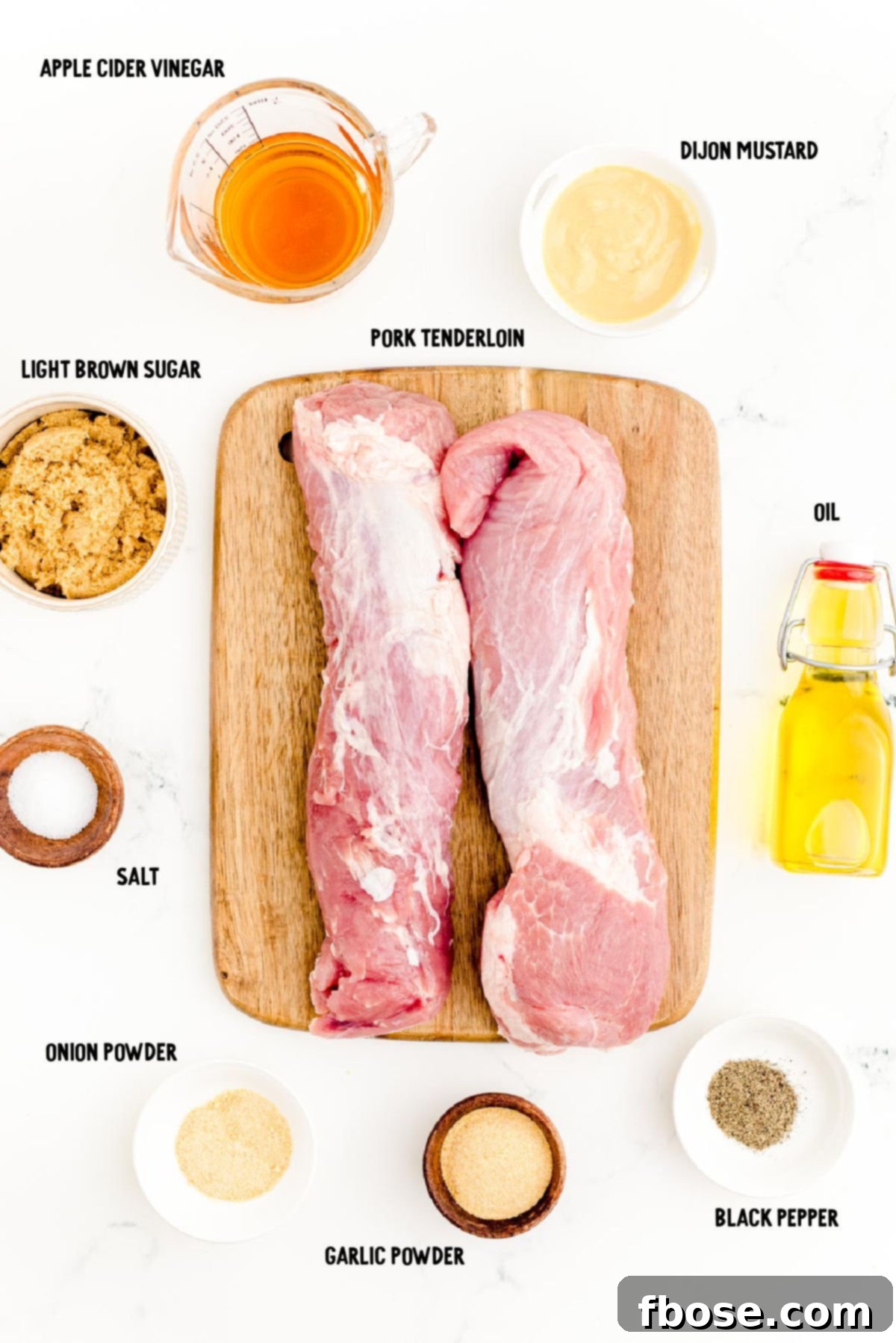 Succulent Grilled Pork Tenderloin 4 Ingredients to make grilled pork tenderloin prepped on a marble surface.