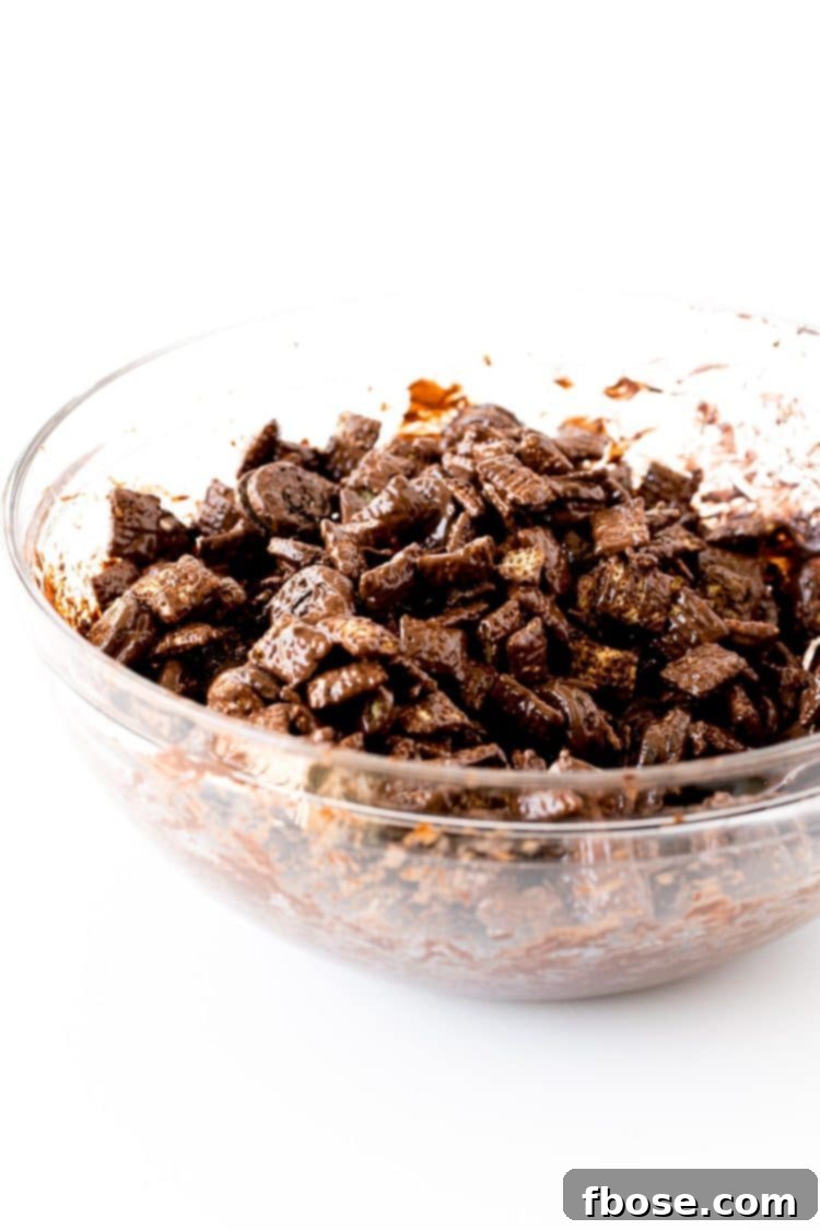 Muddy buddies being prepped in a glass mixing bowl.
