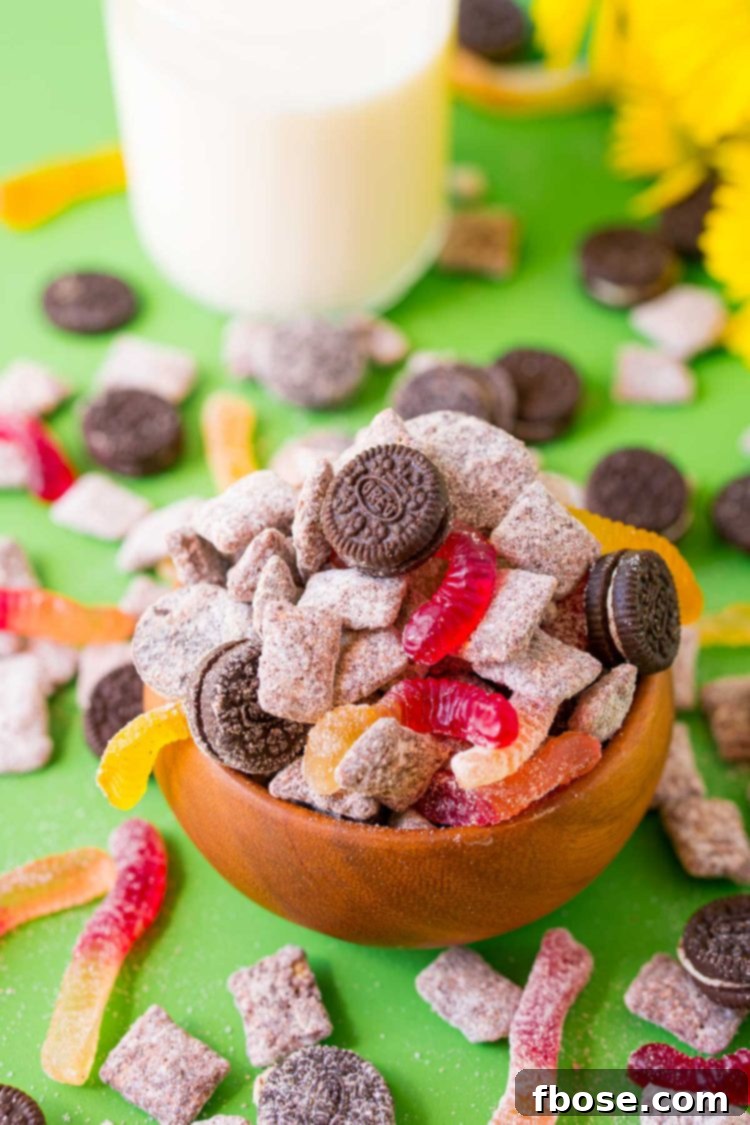 A wooden bowl filled with dirt cake muddy buddies.