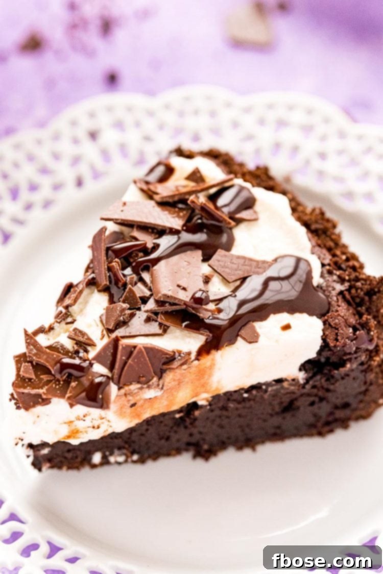 A close-up photo of a decadent slice of Mississippi Mud Pie served on a white plate, showcasing its layers and rich chocolate appeal.