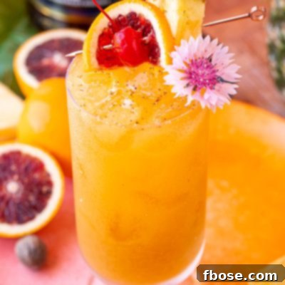 Painkiller cocktail in a stemmed highball glass garnished with a pineapple wedge, orange slice, maraschino cherry and a flower.