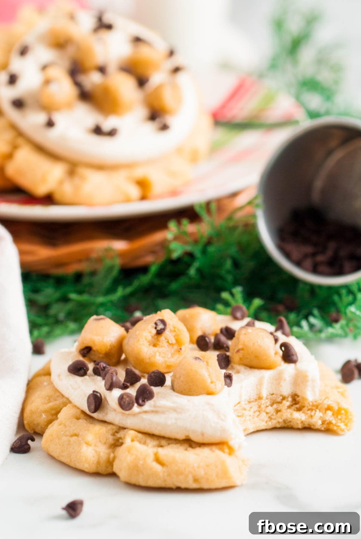 A crumbl copycat cookie dough cookie on a counter with a bite taken out of it.