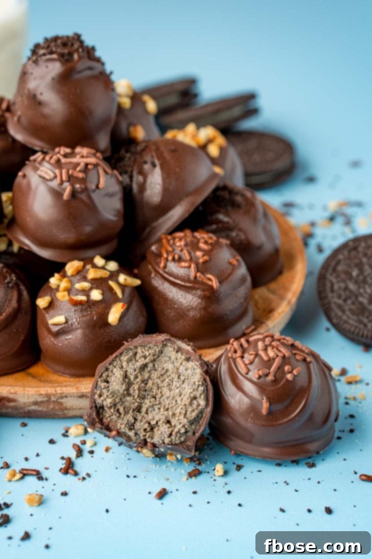 Peanut Butter Oreo Balls on a wooden plate on a blue surface.