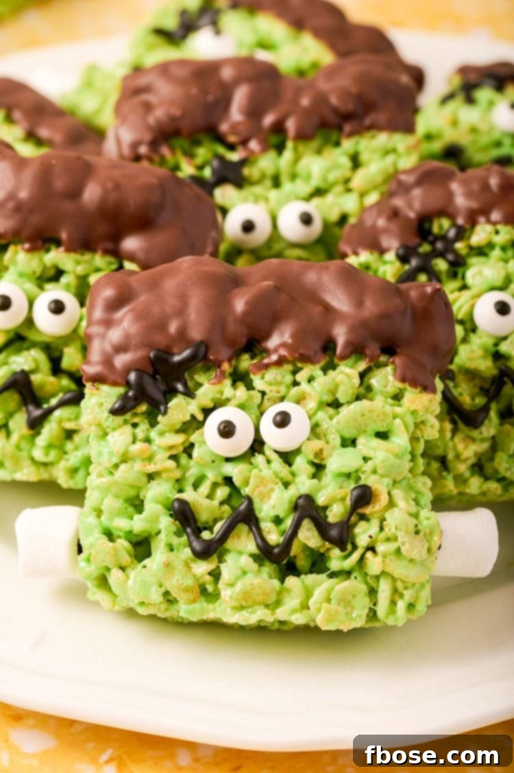 Close up of Frankenstein decorated Rice Krispie Treats on a white plate.