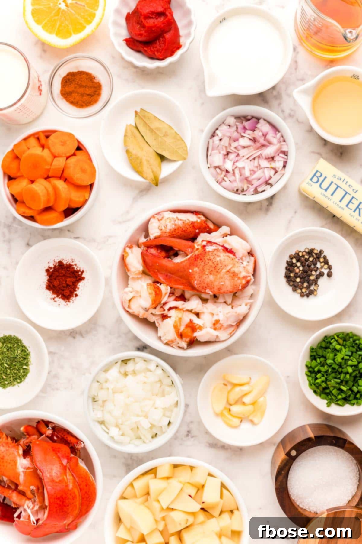 Ultimate Lobster Bisque From Scratch 4 Ingredients to make lobster bisque on a marble table.