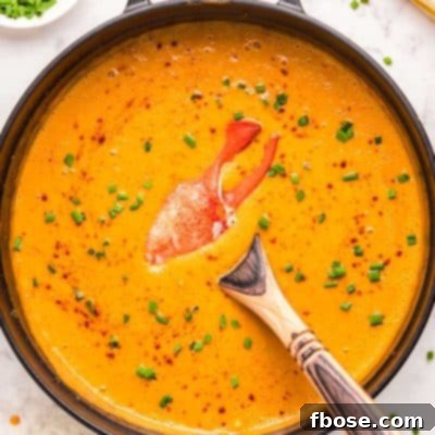 Ultimate Lobster Bisque From Scratch 7 Overhead photo of a Dutch oven filled with lobster bisque.