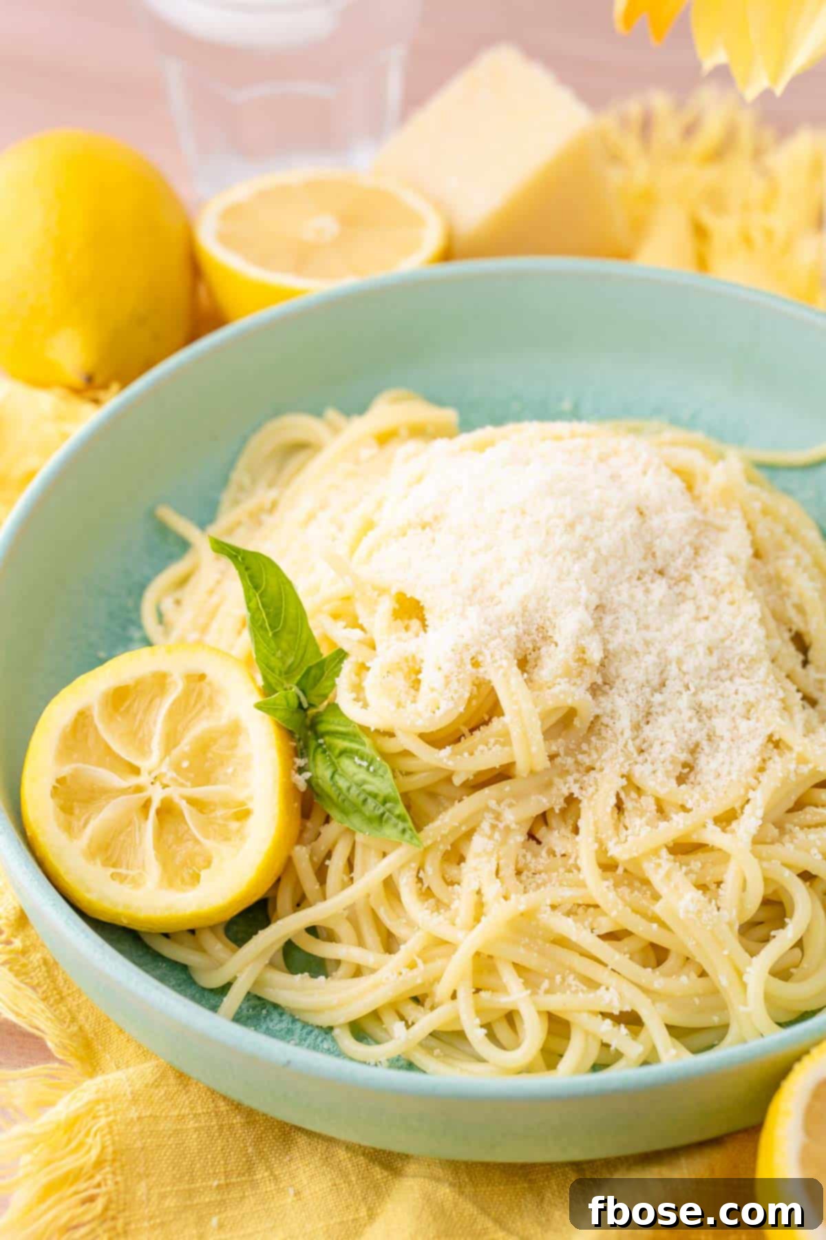 TikTok Lemon Pasta in a mint green bowl, beautifully plated and ready to be enjoyed.