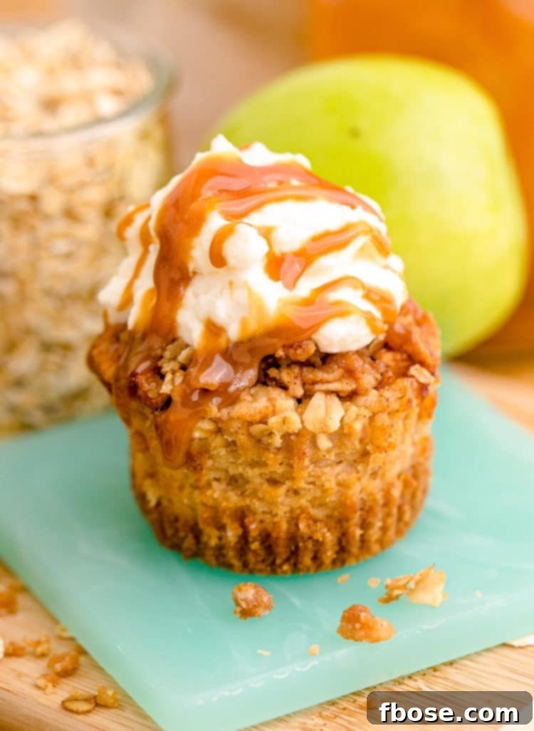A perfectly portioned mini caramel apple cheesecake, served on a small teal coaster, ready to be enjoyed.