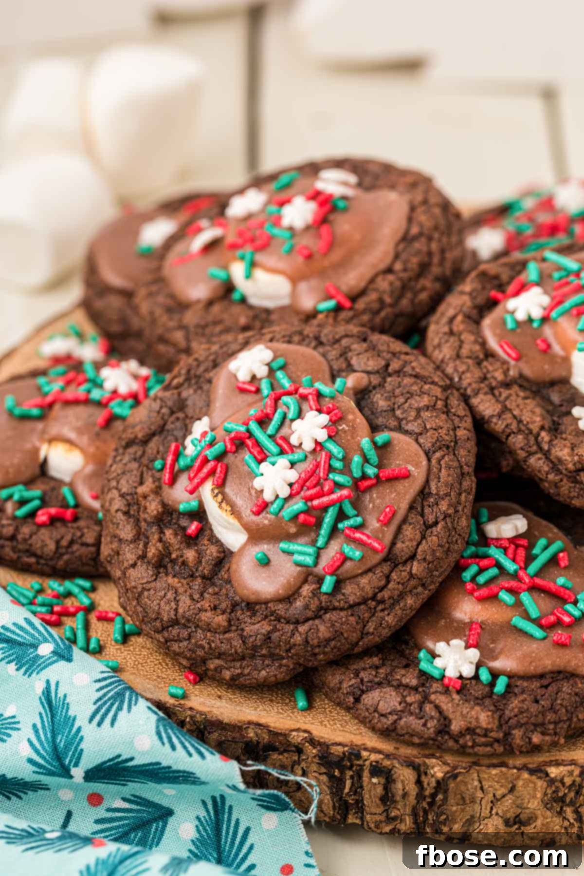 Hot chocolate cookies made from brownie mix on a wooden serving tray, garnished with sprinkles.
