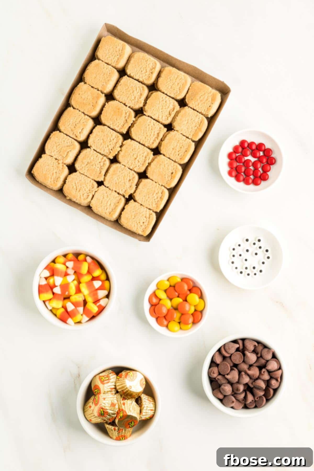 Ingredients to make cookies decorated like turkeys on a marble counter.