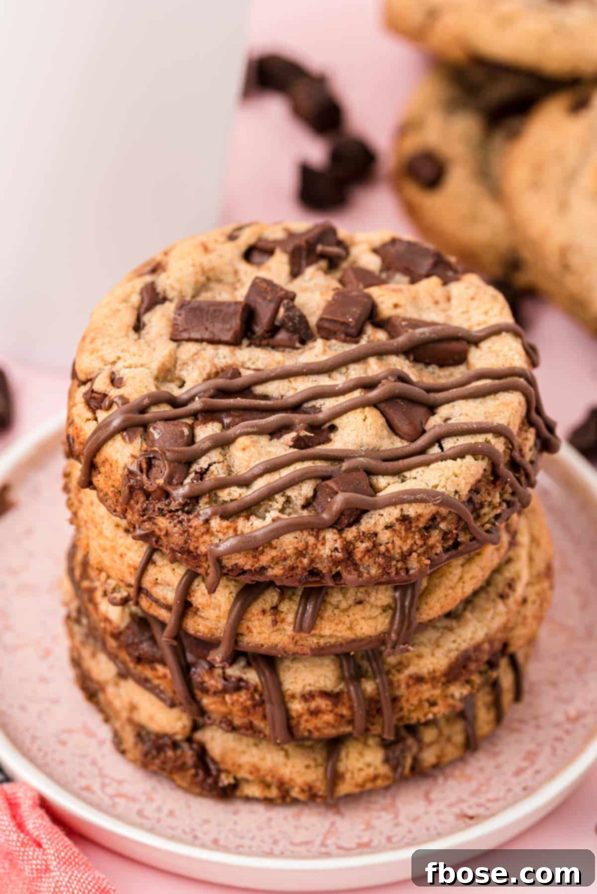 The Ultimate Brown Butter Chocolate Chips 7 Brown butter chocolate chip cookies stacked on a plate.