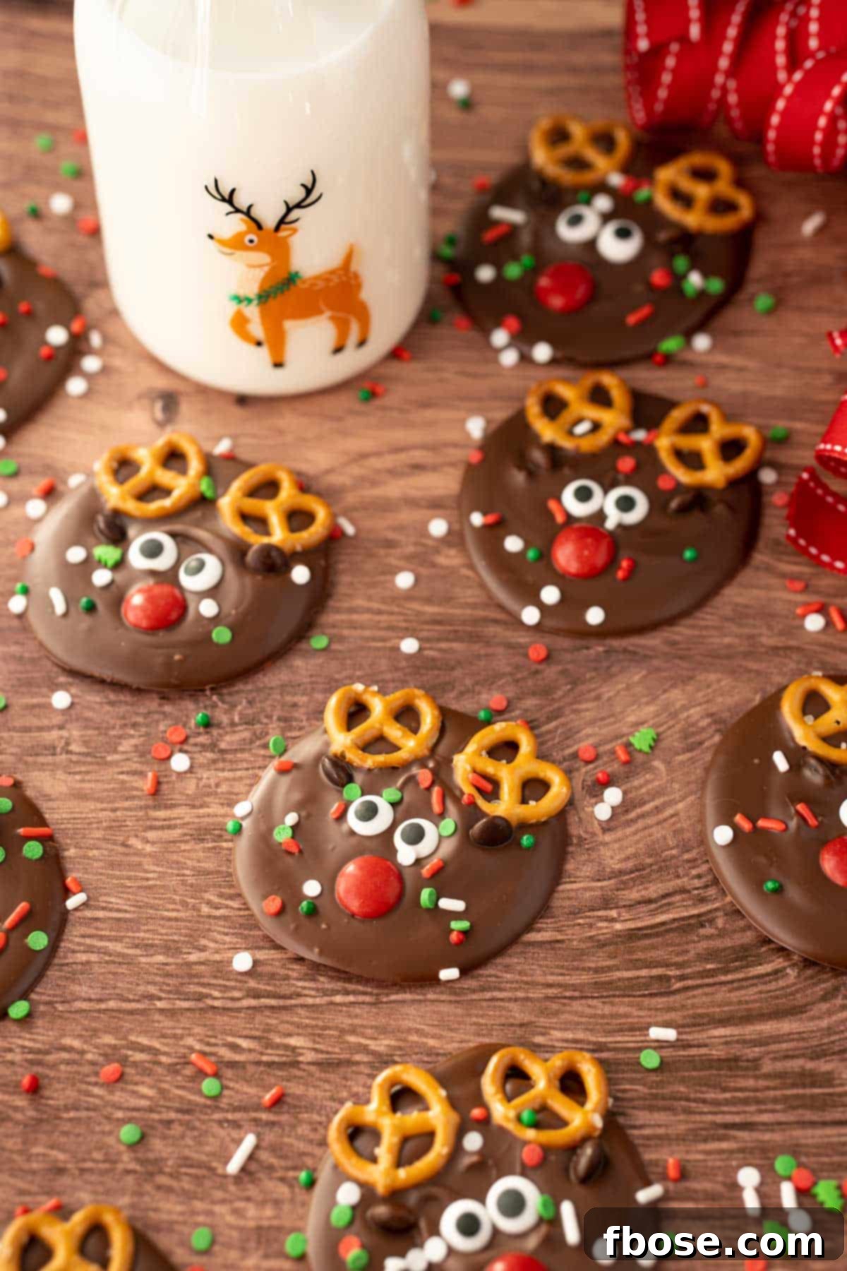 North Pole Bark 5 A festive array of Reindeer Christmas Bark pieces elegantly arranged on a wooden table, sprinkled with vibrant holiday colors.