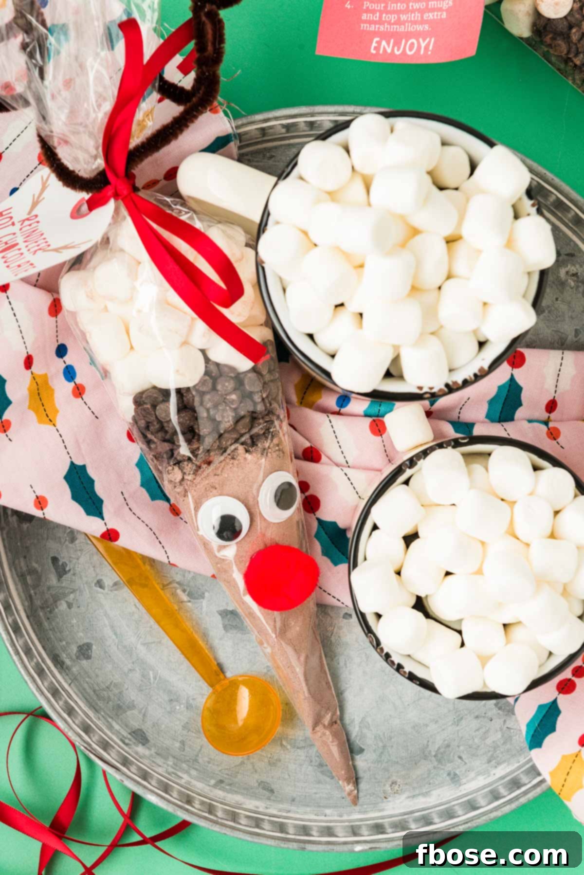 Reindeer hot chocolate cone on a tray with mugs of hot chocolate.