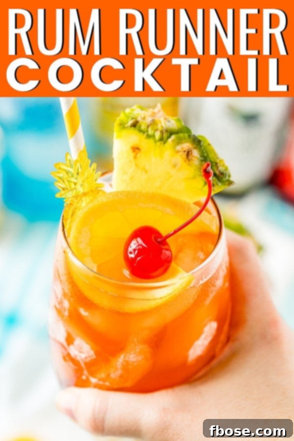  Hand Holding a Rum Runner Cocktail garnished with orange, pineapple, and orange.  