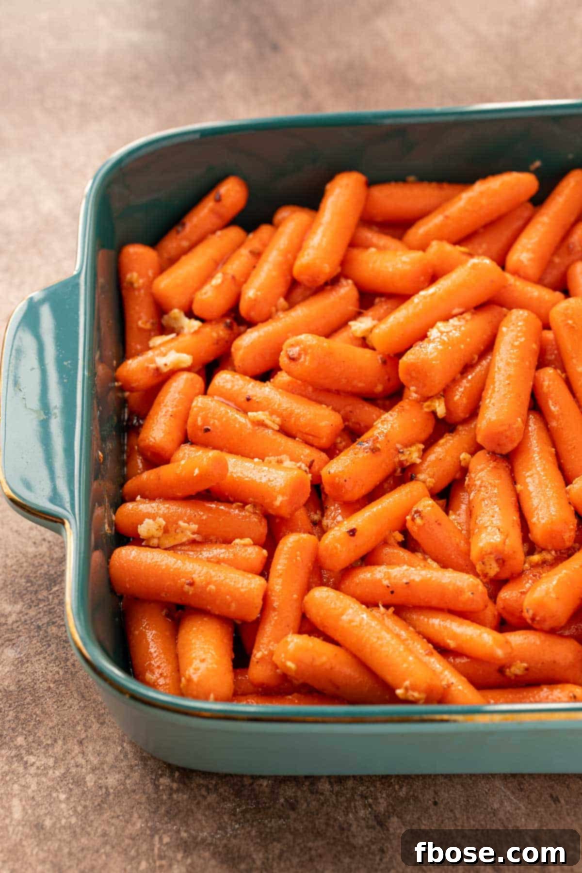 Irresistible Hot Honey Glazed Carrots 4 Carrots in a baking dish ready to roast.