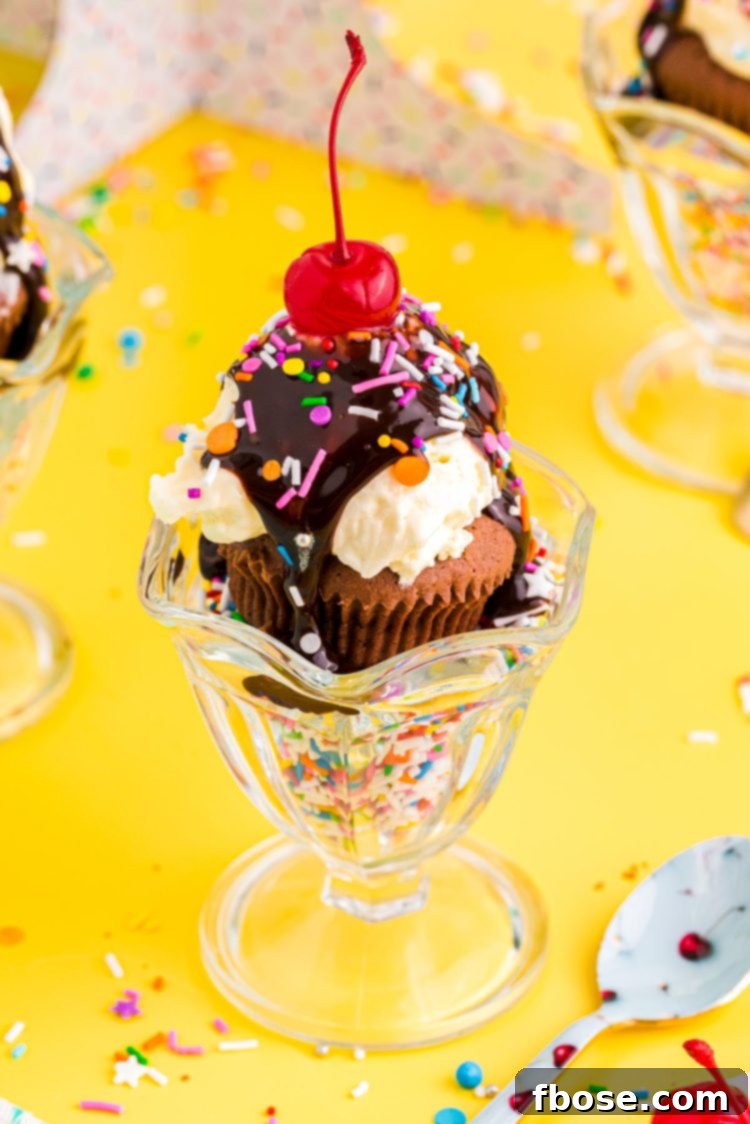 Close up photo of brownie cupcakes in a sundae dish filled with sprinkles on a yellow table.