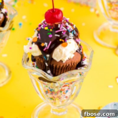 Close up photo of brownie cupcakes in a sundae dish filled with sprinkles on a yellow table.