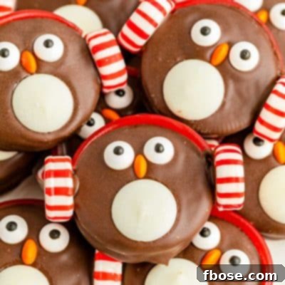 Close up photo of Oreo Penguin Cookies piled on a white plate.