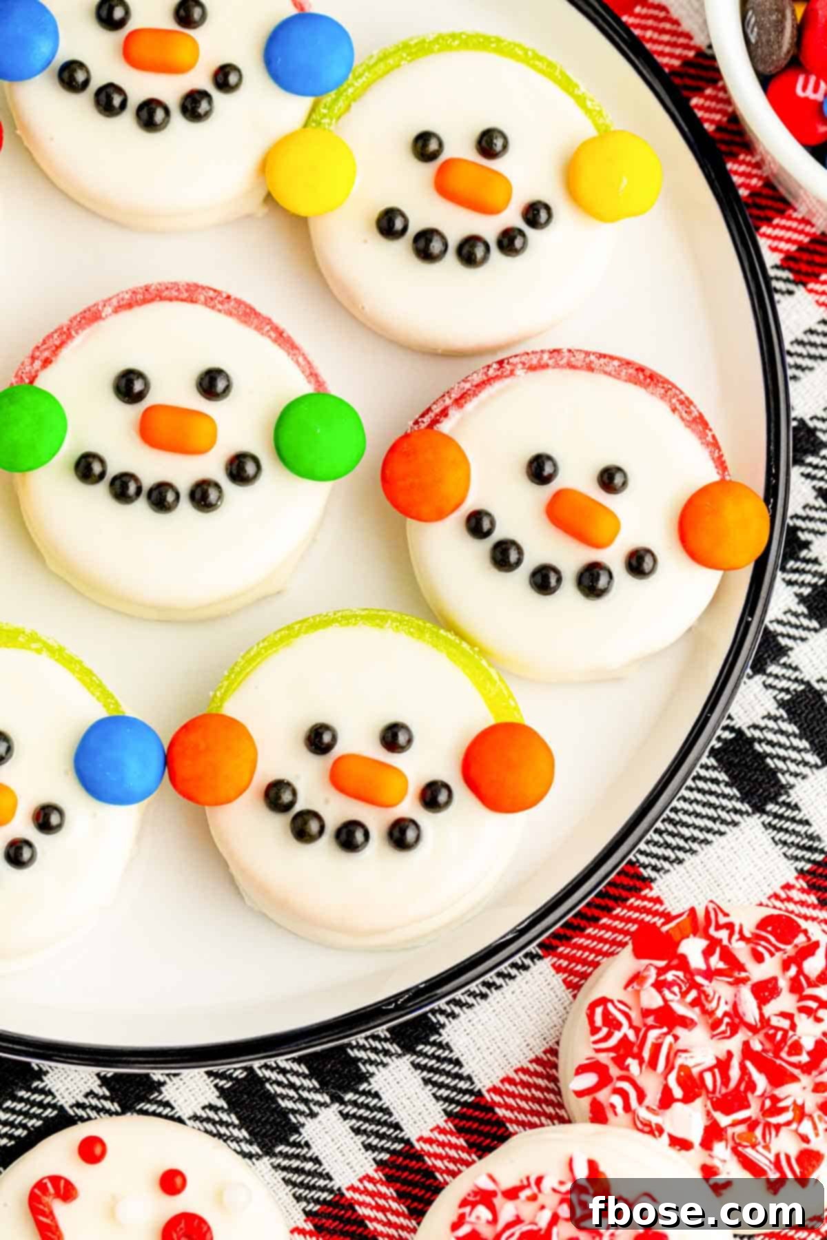A close up of Oreo Snowman Cookies on a white plate.