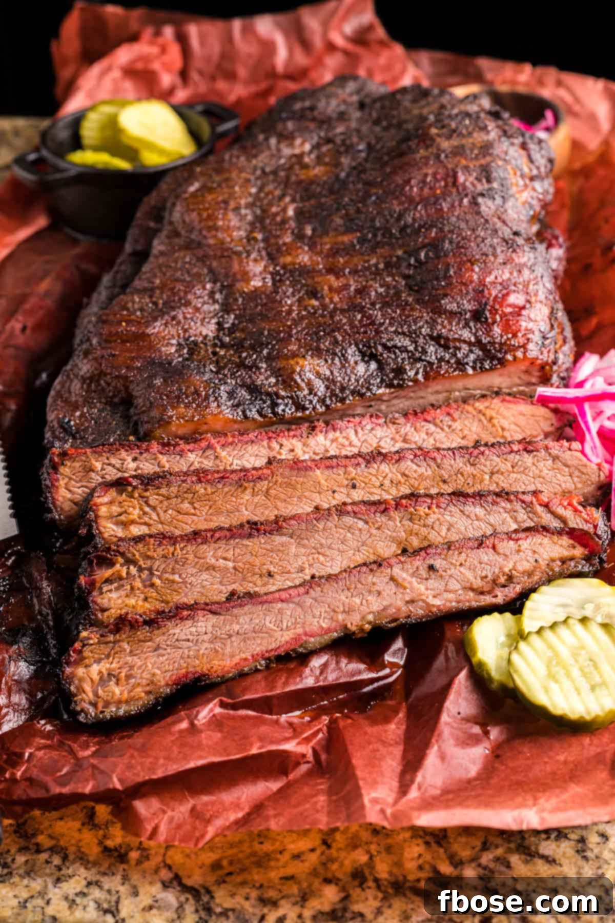 Slow-Smoked Brisket Perfection 2 Perfectly sliced smoked beef brisket on butcher paper, showcasing its juicy interior and flavorful bark.