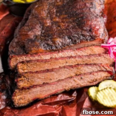 Slow-Smoked Brisket Perfection 7 A smoked brisket that's been partially sliced on paper.