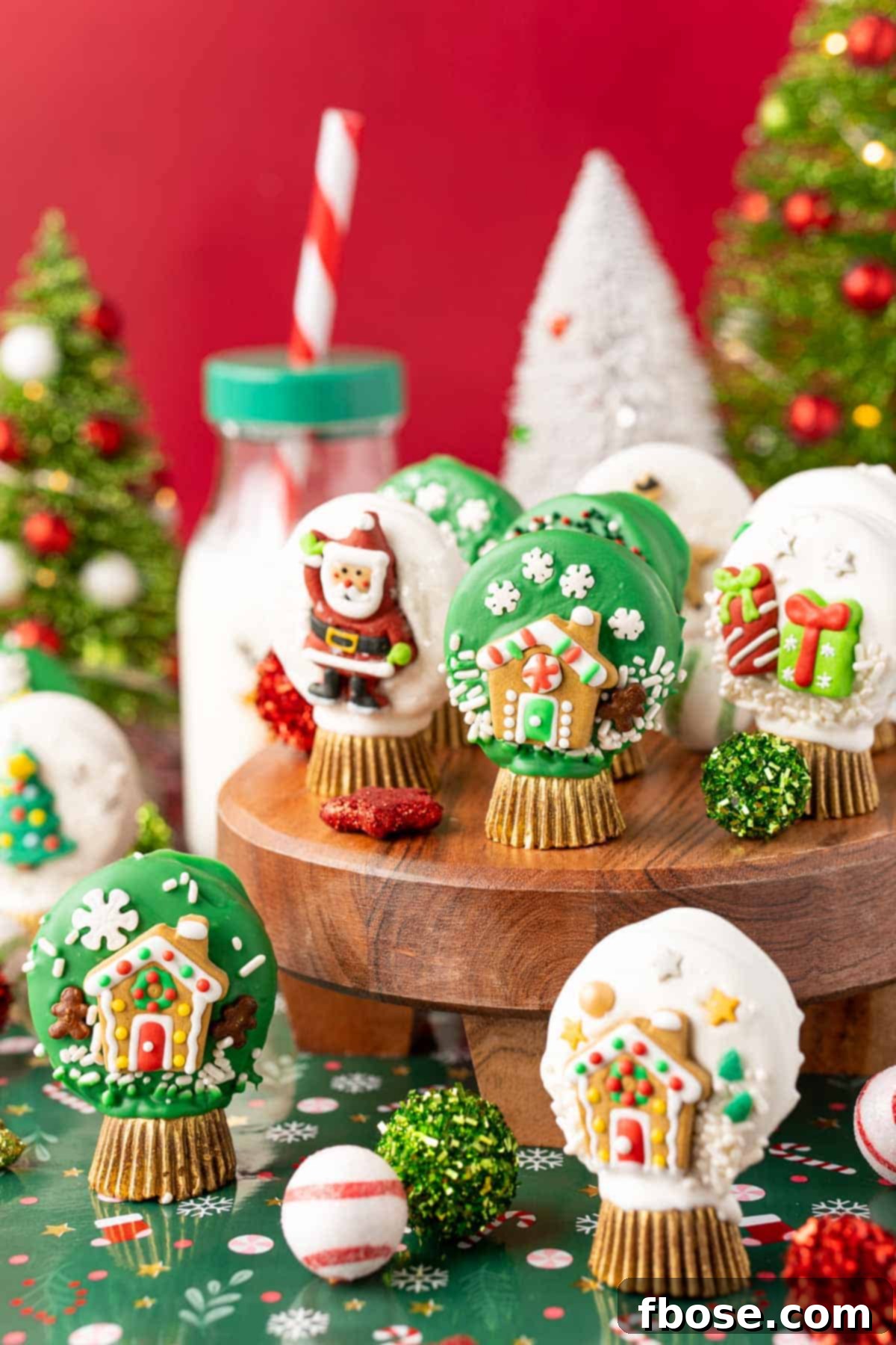 Oreo Snow Globe Cookies on a wooden cake stand.
