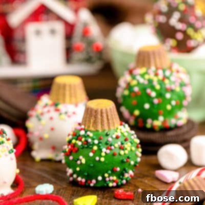 Oreo Ball Ornaments on a wooden table surrounded but holiday decorations.