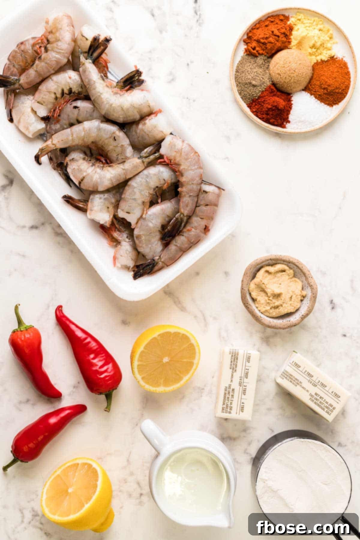 Overhead photo of all ingredients laid out on a marble counter, ready to make wild west shrimp.