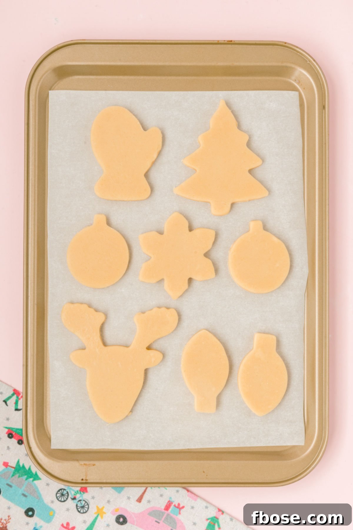 Cut out sugar cookies on a baking pan ready to bake.