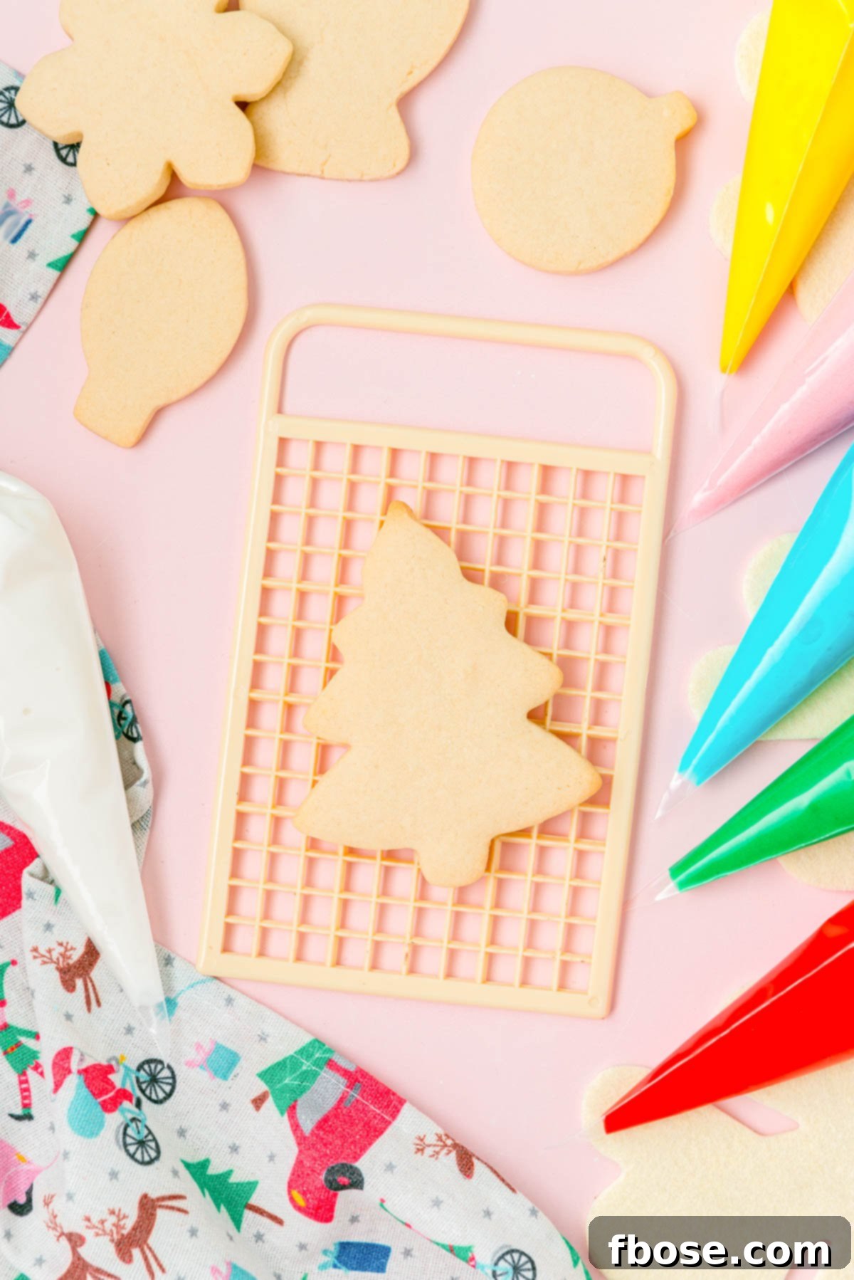 Overhead photo of cutout sugar cookies on a board ready to be frosted.