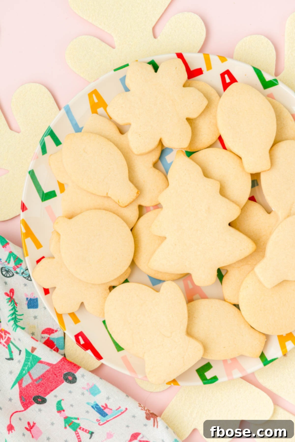 Overhead photo of unfrosted sugar cookies on a plate.