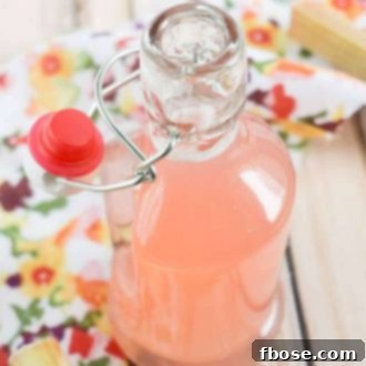 Delicious Rhubarb Simple Syrup in a jar, ready for use.