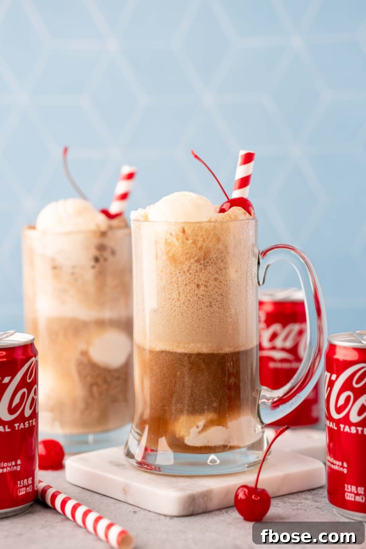 A glass stein filled with a coke float.