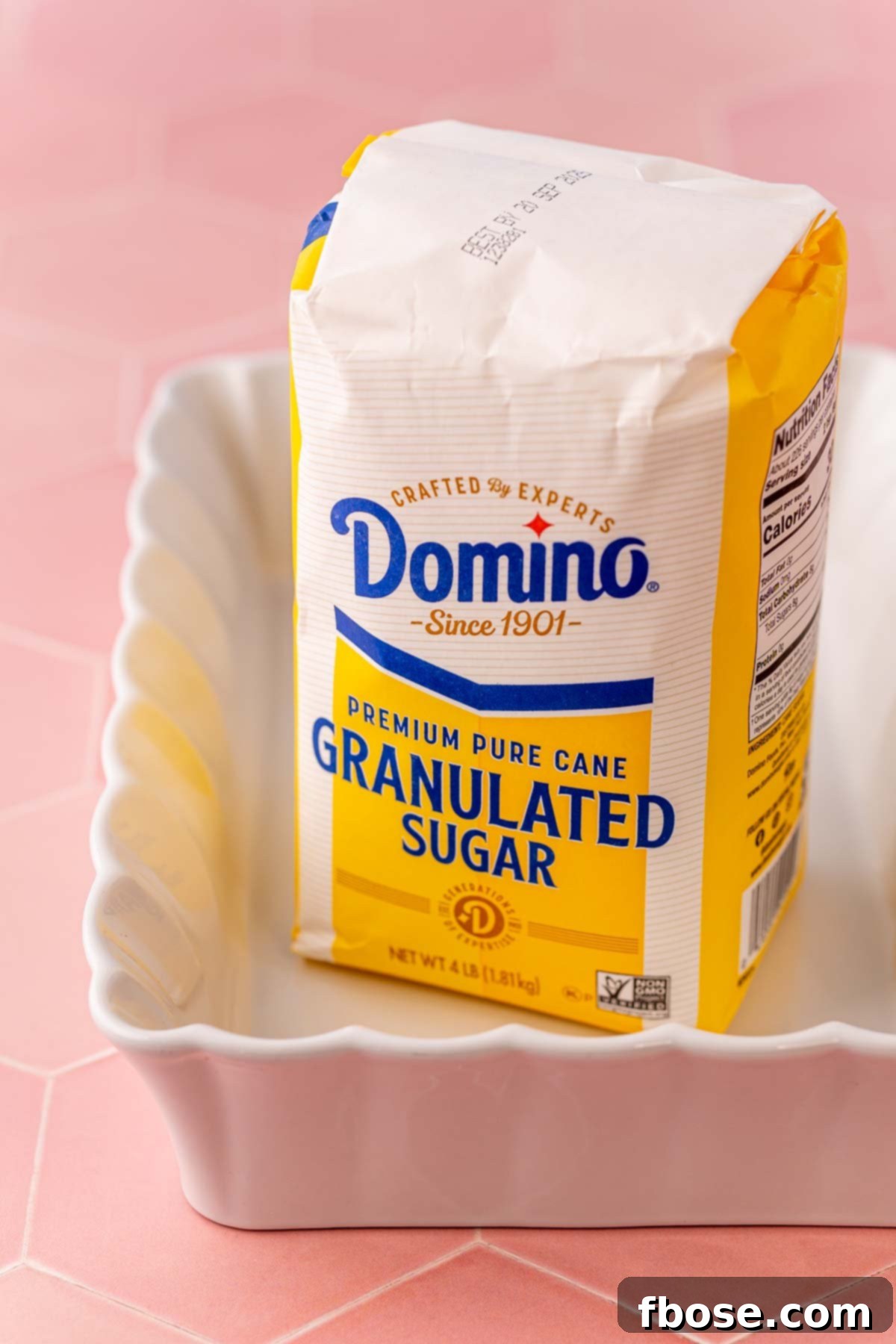 The Secret to Toasted Sugar 3 A bag of Domino granulated sugar poured into a white ceramic baking dish, ready for toasting.
