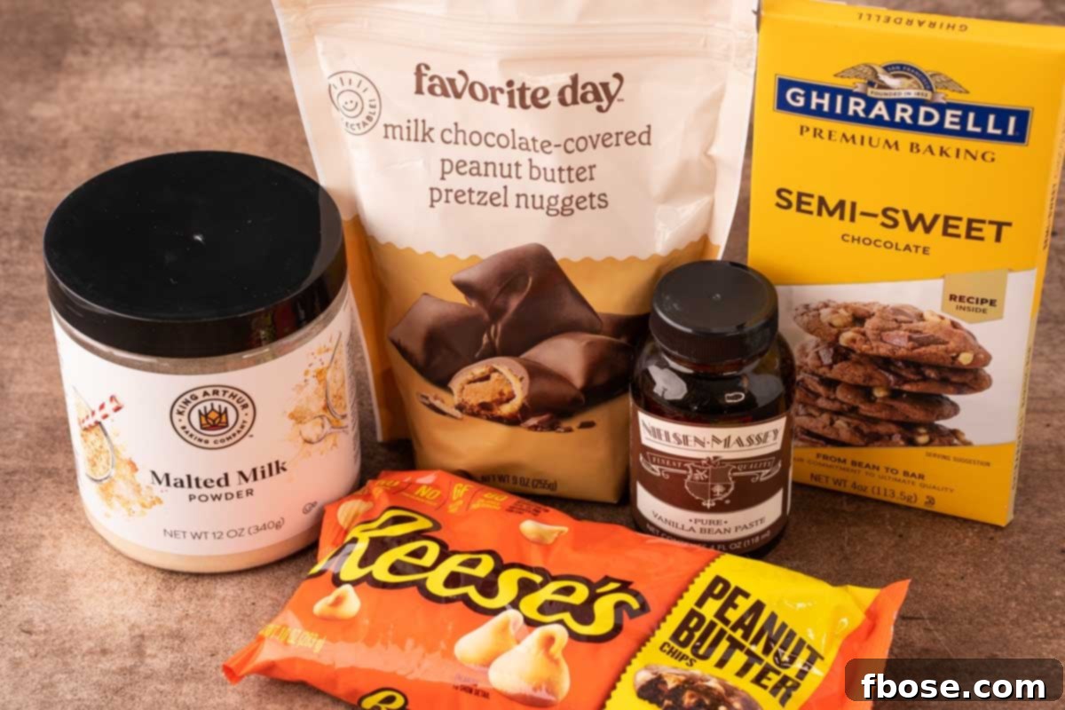 Ultimate Comfort Cookies 5 Various ingredients for making Chubby Hubby Cookies artfully arranged on a rustic brown countertop, including flours, sugars, butter, eggs, chocolate, and pretzels.