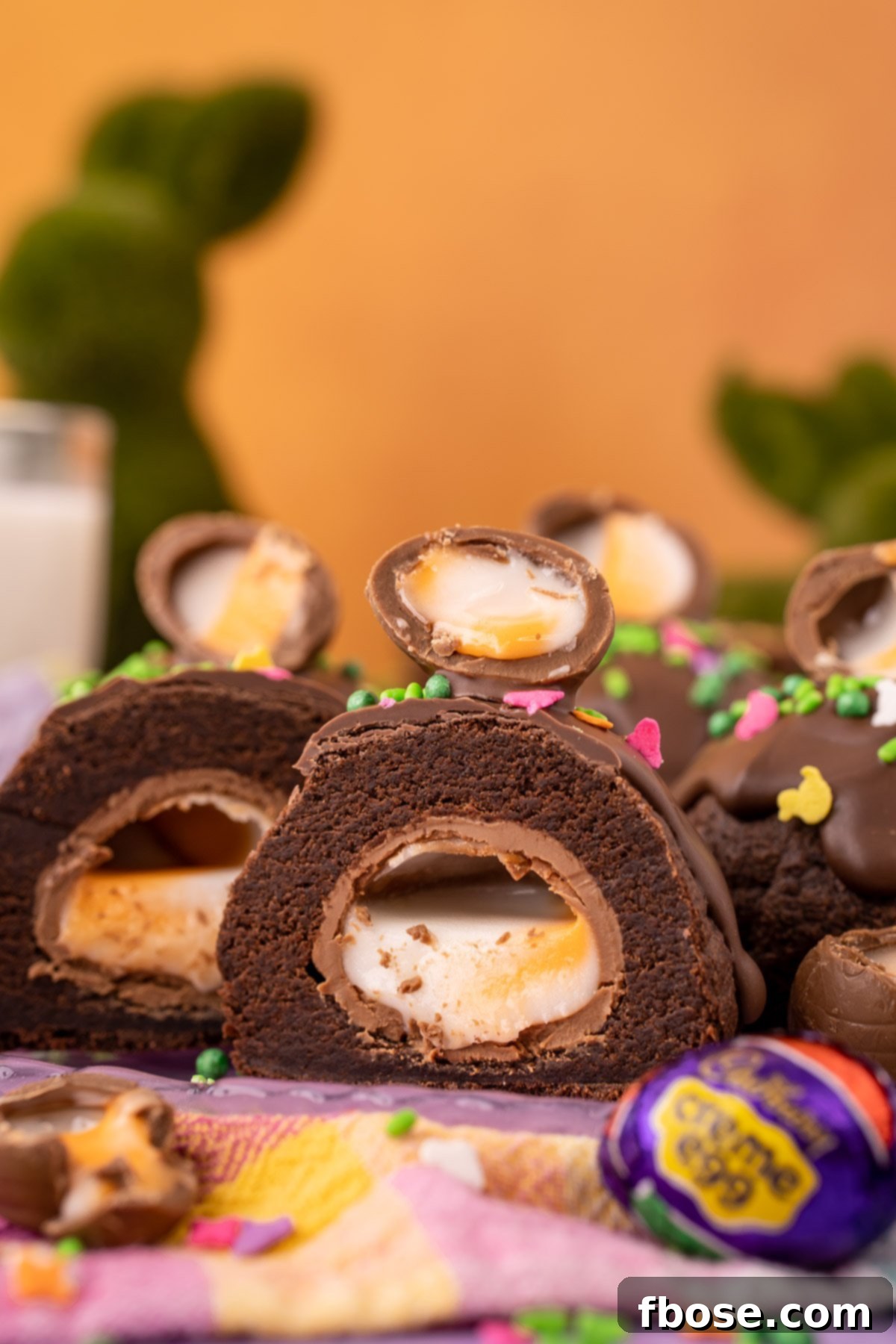 Ultimate Cadbury Creme Egg Cookies 3 A chocolate cookie stuffed with a Cadbury Creme Egg that's been sliced in half to reveal the inside.
