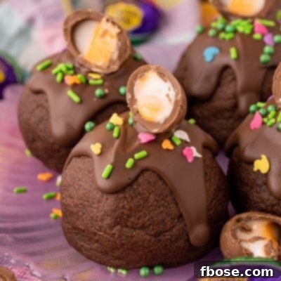 Ultimate Cadbury Creme Egg Cookies 8 Cadbury Creme Egg Cookies on a purple plate.