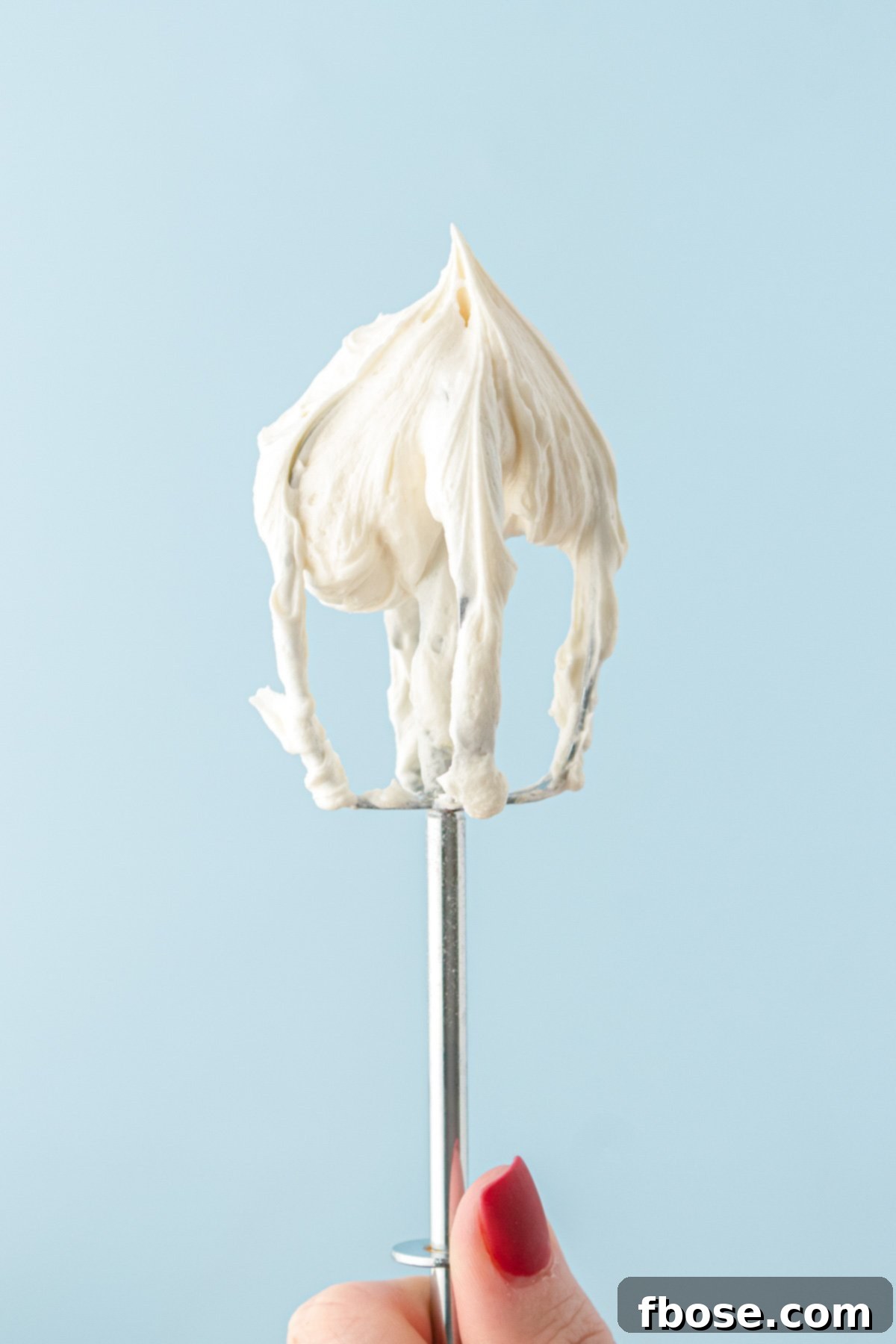 Vanilla frosting on a beater.