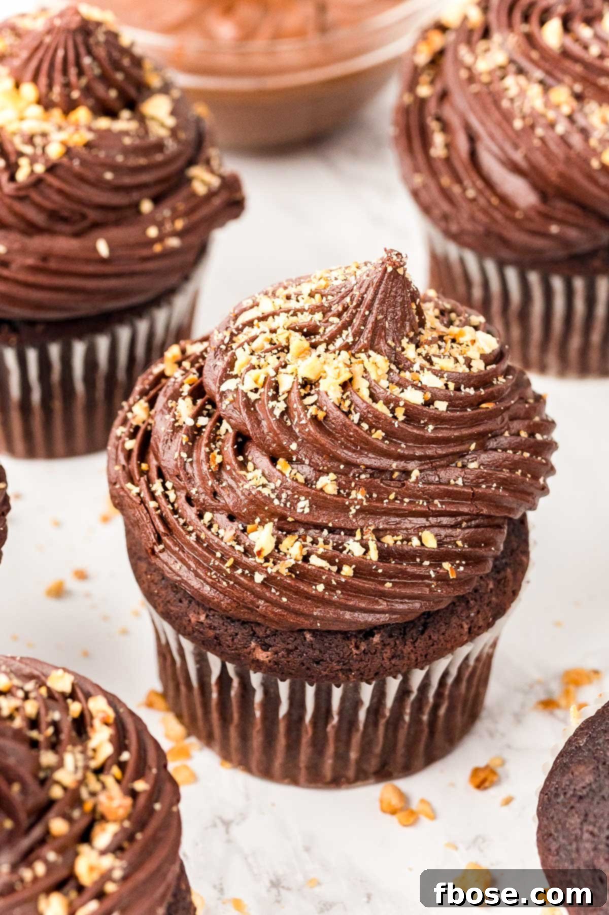 Decadent Nutella Cupcakes 2 Close up of beautifully frosted Nutella Cupcakes, showcasing their rich chocolate color and hazelnut topping.