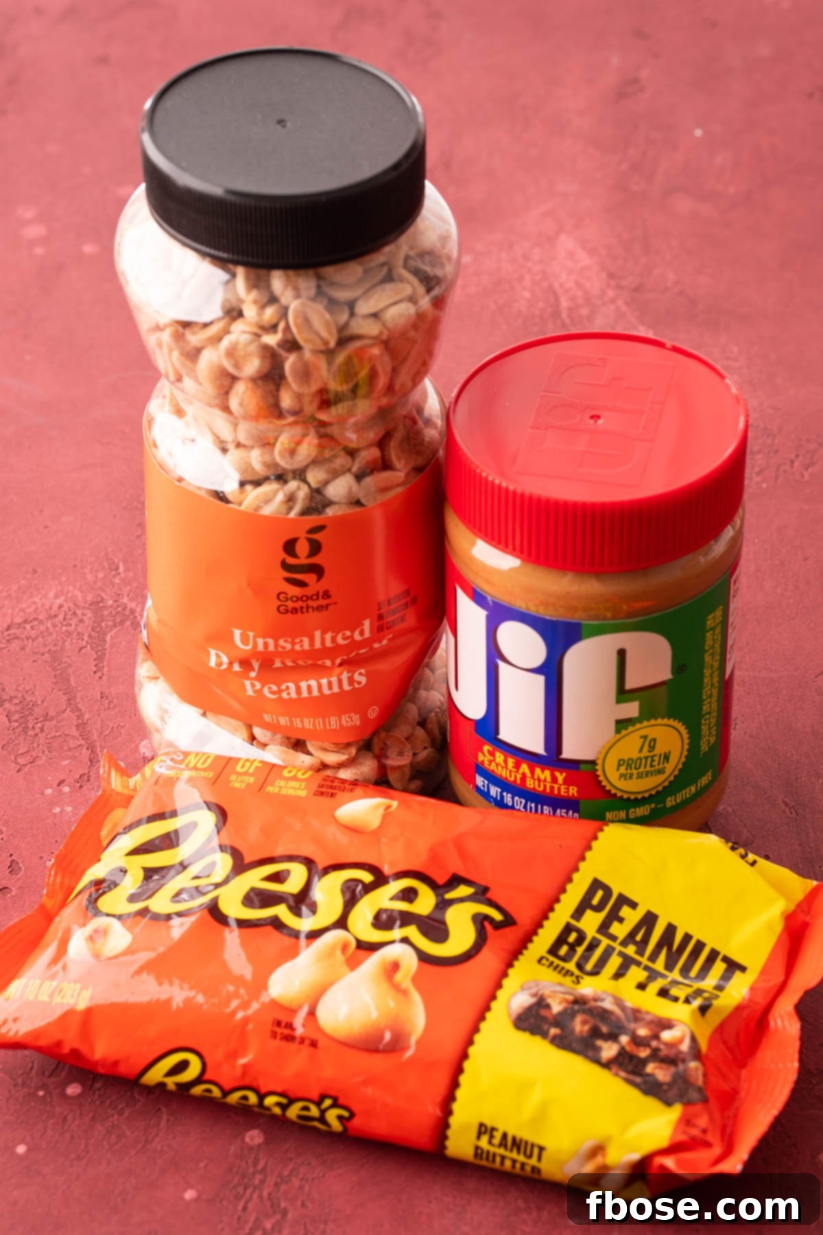 Gourmet Peanut Butter Delights 4 A container of peanuts, peanut butter, and a bag of peanut butter chips on a table.
