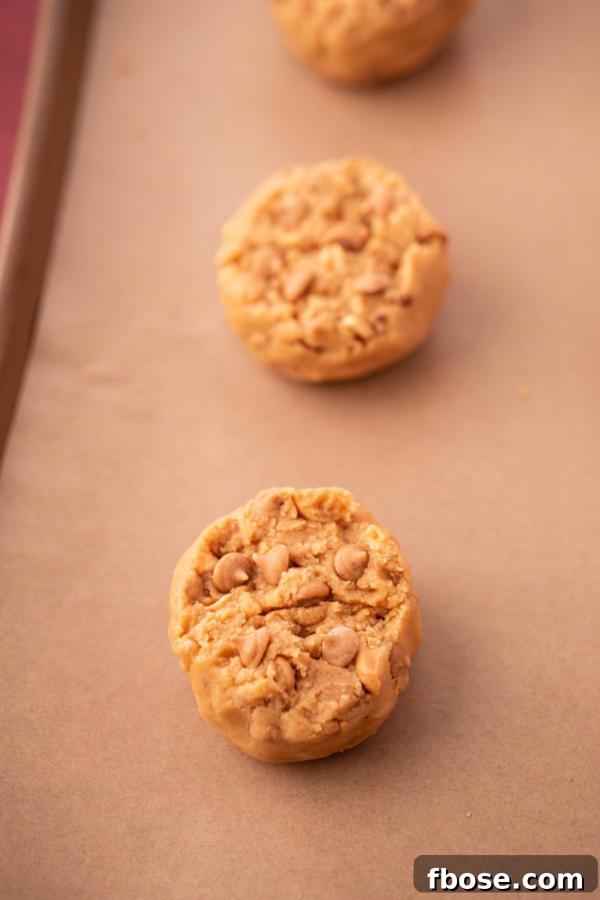 Gourmet Peanut Butter Delights 6 Triple Peanut Butter Cookie Dough balls on a baking sheet lined with parchment paper.
